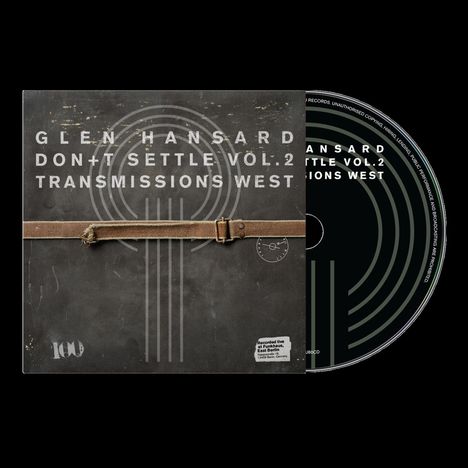 Text: "Glen Hansard Don't Settle Vol. 2 Transmissions West." Ein Albumcover mit einem Lederriemen auf grauem Hintergrund, daneben eine CD.