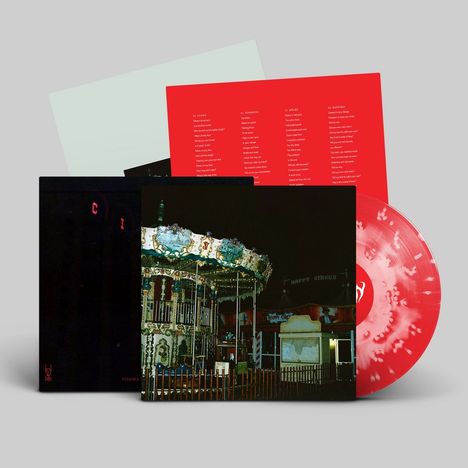 Rote Vinyl-Schallplatte, darauf: Liedtexte. Dunkles Cover zeigt ein Karussell bei Nacht.
