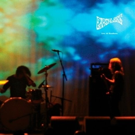 Oben rechts der Text "EARTHLESS Live At Roadburn". Bühne mit zwei Musikern vor farbenfrohem Hintergrund.
