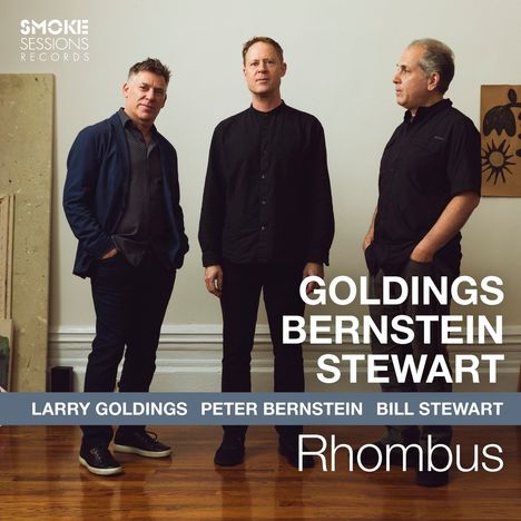 "Goldings Bernstein Stewart", "Larry Goldings Peter Bernstein Bill Stewart", "Rhombus". Drei Männer in lässiger Kleidung stehen.