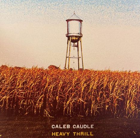 Text: "CALEB CAUDLE" "HEAVY THRILL". Illustration zeigt ein Wasserreservoir über einem goldenen Maisfeld unter blauem Himmel.