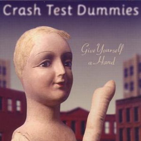 Text: "Crash Test Dummies" und "Give Yourself a Hand". Eine Schaufensterpuppe hebt ihre Hand vor einer städtischen Kulisse.
