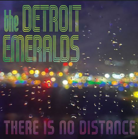 Texte: "the DETROIT EMERALDS" und "THERE IS NO DISTANCE". Hintergrund: Lichter unscharf, mit Regentropfen.