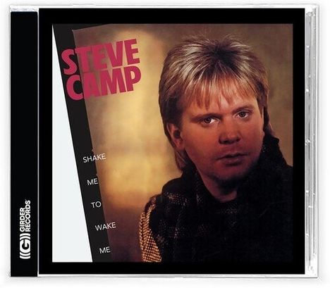 "STEVE CAMP" in roter Schrift, "SHAKE ME TO WAKE ME" vertikal. Ein Mann mit blondem Haar blickt ernst.