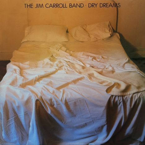 "The Jim Carroll Band · Dry Dreams" ist zu lesen. Ein ungemachtes Bett mit zerwühltem weißen Laken und Kissen.