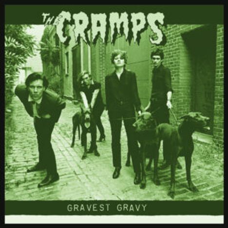 "The Cramps" und "Gravest Gravy". Eine Band posiert in einer Gasse, zwei Männer halten Hunde an Leinen.