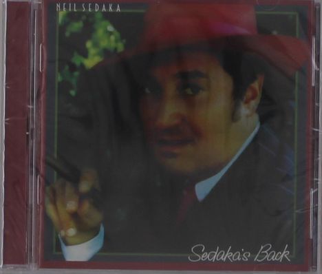 "Neil Sedaka" oben, "Sedaka's Back" unten. Ein Mann in rotem Hut mit Pfeife.