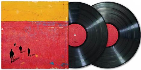 Text: keine sichtbaren Details. Cover in Gelb und Rot, zeigt schwarze Silhouetten von vier Personen. Zwei Schallplatten daneben.