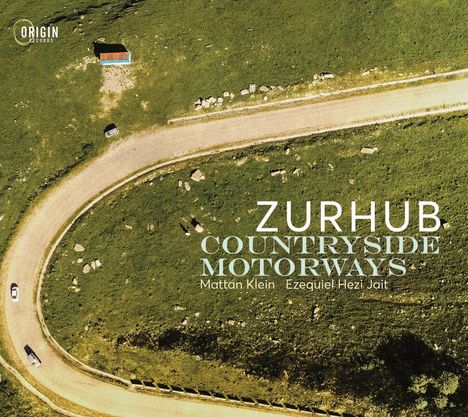 "ZURHUB COUNTRYSIDE MOTORWAYS" steht auf einer Luftaufnahme von einer kurvigen Straße in grüner Landschaft.