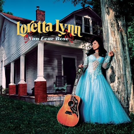 Texte: "Loretta Lynn" und "Van Lear Rose". Eine Frau in blauem Kleid lehnt an einem Baum, eine Gitarre steht neben ihr.