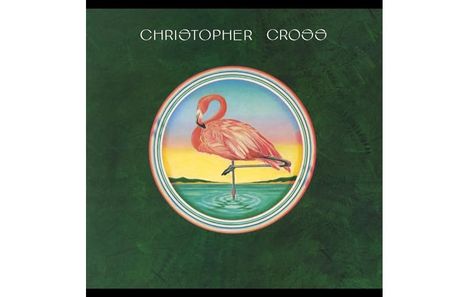 "CHRISTOPHER CROSS" in weißer Schrift auf grünem Hintergrund. Illustration: Flamingo im Wasser, Sonnenuntergang im Hintergrund.