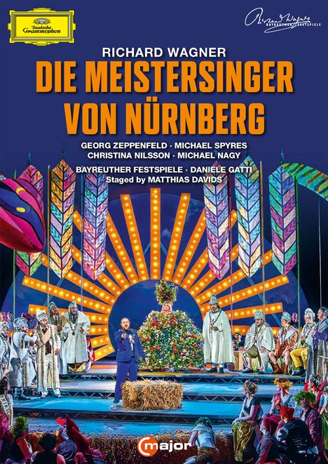 Titel: "Die Meistersinger von Nürnberg". Bunte Opernszene mit Darstellern in historischen Kostümen und heller Beleuchtung.