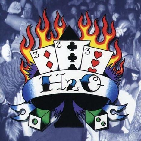 Text: "H2O." Illustration: Spielkarten mit Flammen, Pik- und Würfelsymbole. Im Hintergrund Menschenmenge.