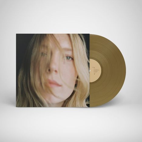 Seite A: Liedtitel auf einem beigen Etikett einer olivfarbenen Vinyl-Schallplatte. Cover zeigt das Gesicht einer Frau.