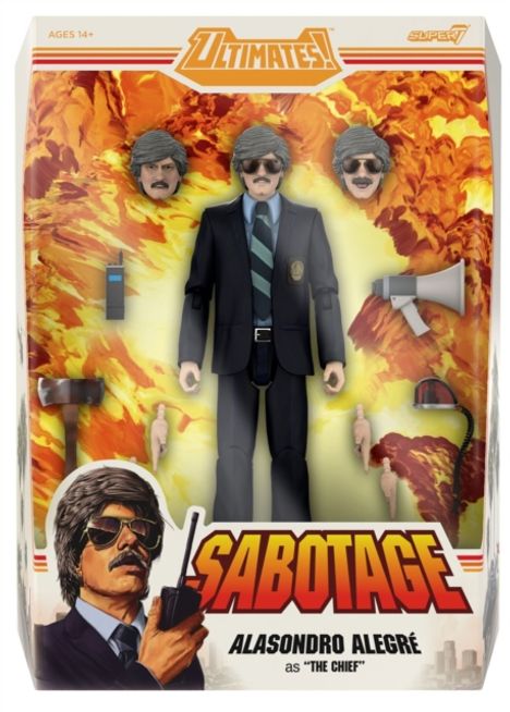 "ULTIMATES!", "SABOTAGE", "ALASONDRO ALEGRÉ as 'THE CHIEF'". Eine Actionfigur in schwarzem Anzug mit Accessoires.