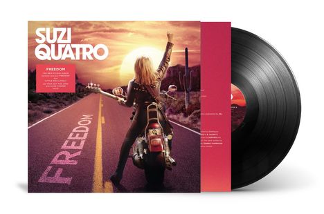 Die Worte "SUZI QUATRO" und "FREEDOM" sind prominent. Eine Person auf einem Motorrad zeigt in die Ferne. Sonnenuntergang im Hintergrund.