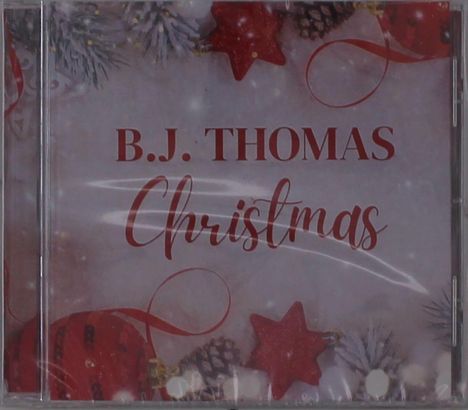 Text "B.J. THOMAS Christmas" in roten Buchstaben, umgeben von roten Sternen, Tannenzapfen und Zweigen.