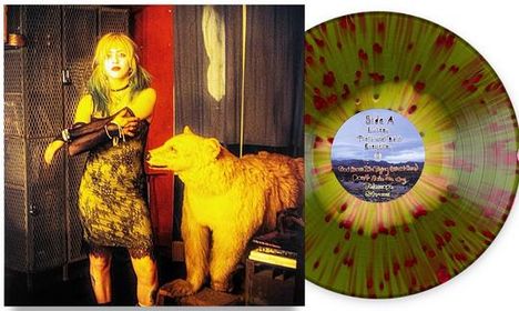 Text auf Schallplatte: "Side A, Lived, Taught, Turned". Frau in gelbem Licht neben ausgestopftem Bären, bunter Vinyl.