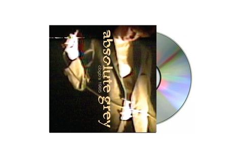 Text: „absolute grey, cbgb's 1985“. Dunkles, verschwommenes Bild eines Live-Auftritts mit einer Person. CD im Hintergrund.