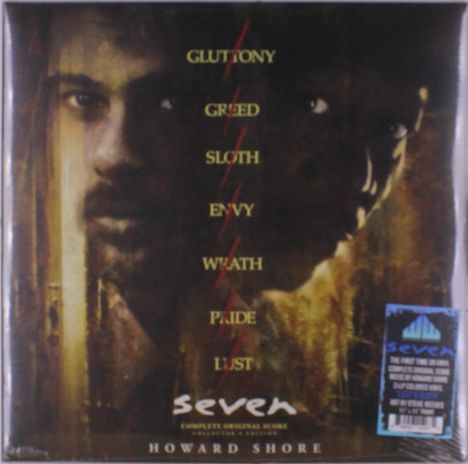 Text: "GLUTTONY, GREED, SLOTH, ENVY, WRATH, PRIDE, LUST, seven, HOWARD SHORE". Zwei Gesichter, düsterer Ton.