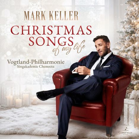 "Mark Keller: Christmas Songs of my Life. Vogtland-Philharmonie Singakademie Chemnitz." Mann im Anzug auf rotem Sessel.