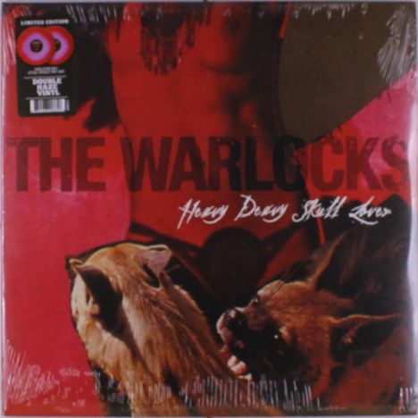 „THE WARLOCKS“ und „Heavy Deavy Skull Lover“ in großen, markanten Buchstaben. Zwei Wölfe und rötliche Hintergrundfarben.