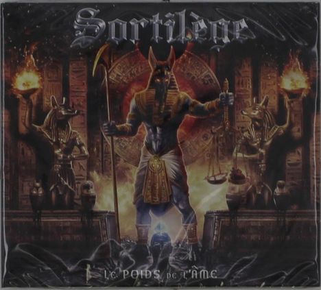Text: "Sortilège", "LE POIDS de L'ÂME". Darstellung von Anubis vor einem antiken ägyptischen Hintergrund mit Flammen.