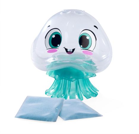 Ein durchsichtiges Spielzeug in Form einer Qualle mit großen Augen und einem Lächeln. Daneben zwei blaue Beutel.