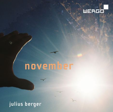 Text: "WERGO", "november", "julius berger". Ein Sonnenlicht blendet, Vögel fliegen am Himmel, eine Hand streckt sich aus.