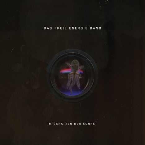 "DAS FREIE ENERGIE BAND" und "IM SCHATTEN DER SONNE". Dunkler Hintergrund mit einer kreisförmigen Illustration.