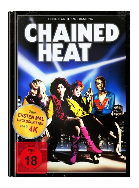 Große Titel "CHAINED HEAT", darunter vier Frauen vor einem nächtlichen Stadthintergrund, gelber Sticker: "ERSTEN MAL 4K".