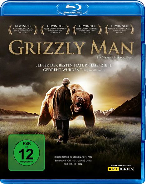"Grizzly Man" oben. Mann und Bär in Landschaft darunter. Text: "In der Natur bestehen Grenzen. Ein Mann hat sie 13 Jahre lang überschritten."