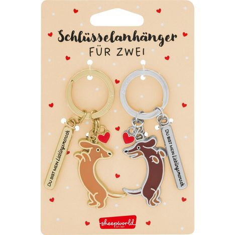 "Schlüsselanhänger für zwei. Du bist mein Lieblingsmensch." Zwei Dackel-Anhänger aus Metall mit Herzen und Schlüsselringen.