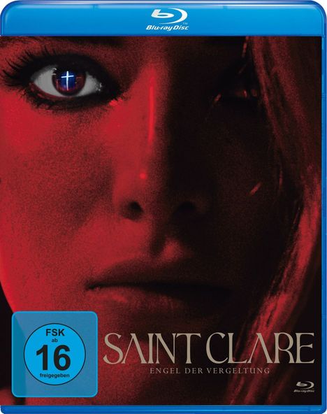 „SAINT CLARE: ENGEL DER VERGELTUNG“ steht auf einem Cover mit rotem Gesicht und einem intensiven Blick. FSK 16.