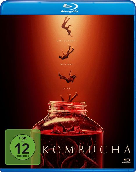 Text: "Die Zukunft beginnt hier", "Kombucha", "FSK ab 12 freigegeben". Illustration: Menschen fallen in ein rotes Glas.