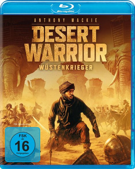 Text: "Anthony Mackie, Desert Warrior, Wüstenkrieger, FSK ab 16 freigegeben." Illustration von Kriegern und Elefanten in der Wüste.