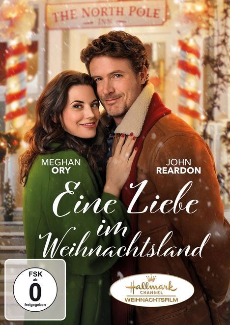 „Eine Liebe im Weihnachtsland“ mit Meghan Ory und John Reardon. Sie umarmen sich vor einem Weihnachts-Inn-Eingang.