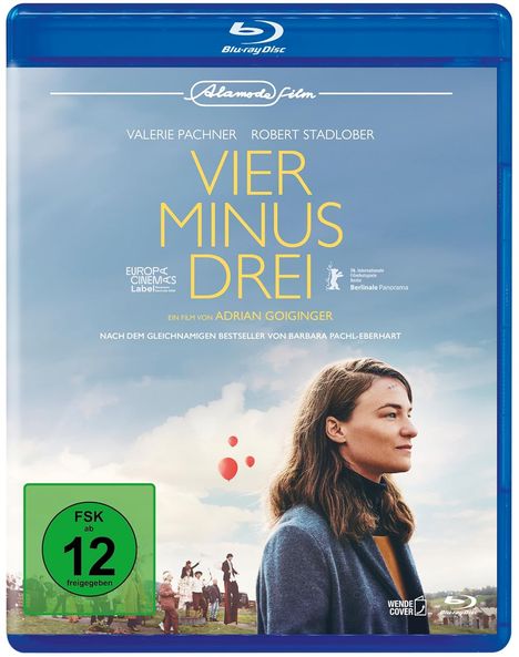 Text: "Blu-ray Disc", "Alamode Film", "Vier Minus Drei", "FSK ab 12". Frau im Profil, Luftballons, Menschen im Hintergrund.