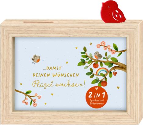 „…DAMIT DEINEN WÜNSCHEN Flügel wachsen!“ und „2 IN 1 Spardose und Bilderrahmen“. Illustration mit Vögeln und Bäumen.