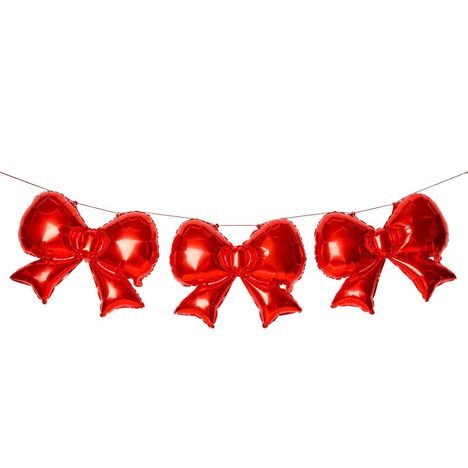 Drei rote Folienballons in Form von Schleifen, an einer Schnur aufgereiht.