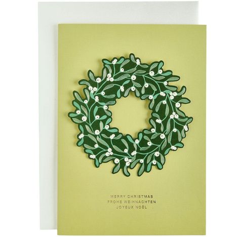 "Merry Christmas, Frohe Weihnachten, Joyeux Noël" steht auf einer Karte mit Mistelkranz-Abbildung.