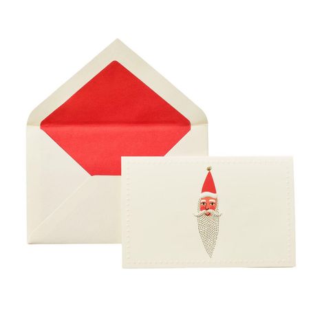 Ein Umschlag mit rotem Innenfutter und eine Karte mit einem stilisierten Weihnachtsmann im roten Hut.