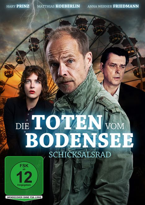 „Die Toten vom Bodensee: Schicksalsrad“ – Drei Personen vor einem Riesenrad, intensiver Blick, stürmischer Himmel.