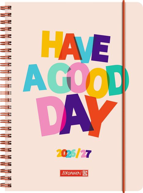 "Have a Good Day", darunter "2026/27" und das Logo "Brunnen". Bunte Buchstaben auf einem spiralgebundenen Notizbuch.