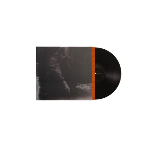 Aufschrift: "Tresor - Mann aus Metall". Zwei schwarze Schallplatten und ein dunkles Cover mit einer Person im Schatten.