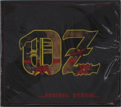 Der Text "...DECIBEL STORM..." erscheint unten. Großes "OZ"-Logo in der Mitte mit metallischen Elementen.