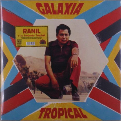 Cover mit „GALAXIA TROPICAL“ in Rot und Gelb, Foto eines Mannes in rotem Anzug kniend, bunter geometrischer Hintergrund.