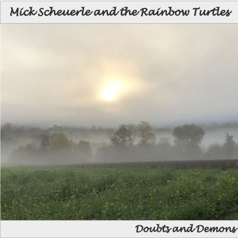 "Mick Scheuerle and the Rainbow Turtles", "Doubts and Demons". Ein nebliger Sonnenaufgang über einem Baum- und Wiesenfeld.