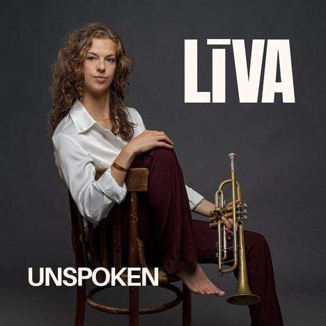 „LIVA“ steht groß oben, „UNSPOKEN“ unten. Eine Person sitzt auf einem Stuhl und hält eine Trompete.