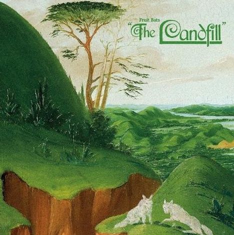 Text: "Fruit Bats 'The Landfill'". Illustration: Grüne Hügel, zwei Wölfe ruhen, ferner Baum und Flusslandschaft im Hintergrund.